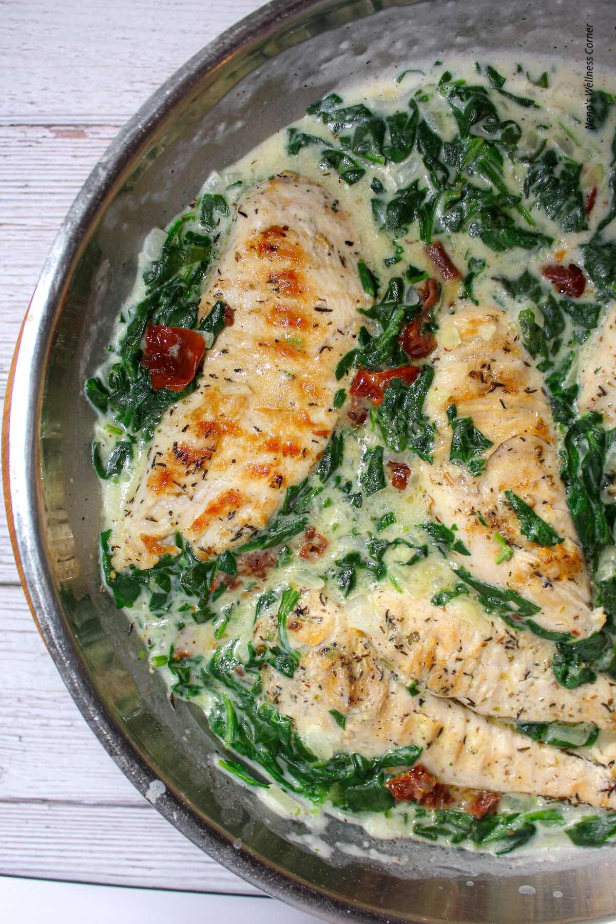 Chicken with spinach in bechamel sauce shown in the pan.