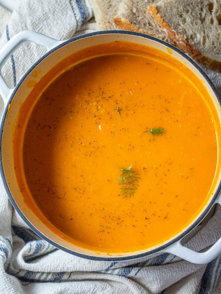 Sweet potato soup with zucchini and garlic in a pot.