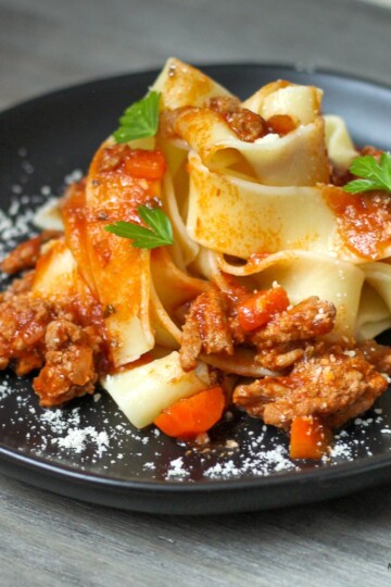 Turkey ragu pasta (turkey mince bolognese) with jar tomato sauce served on a plate