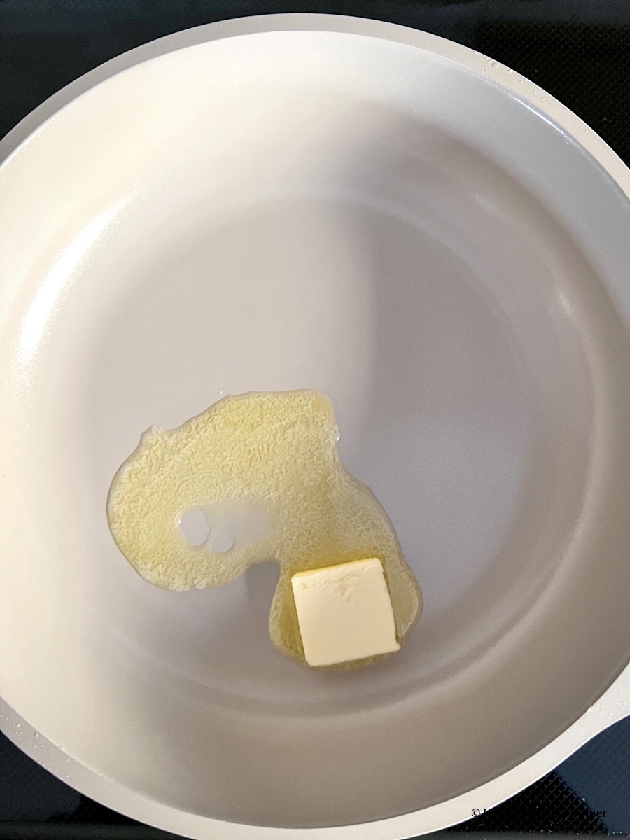 Cheesy Scrambled Eggs, heat the butter in the skillet.