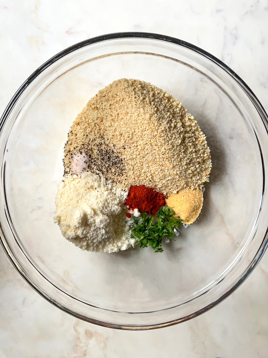 Air Fryer Salmon Bites with Garlic, mix breadcrumbs, garlic powder, parmesan, parsley, and spices.