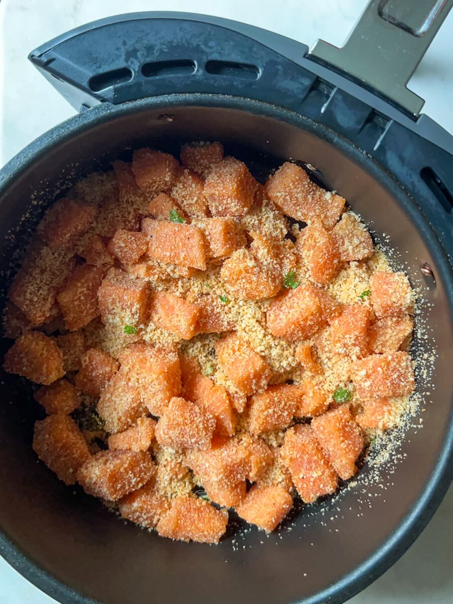 Air Fryer Salmon Bites with Garlic, preheat air fryer and bake until salmon bites are golden.