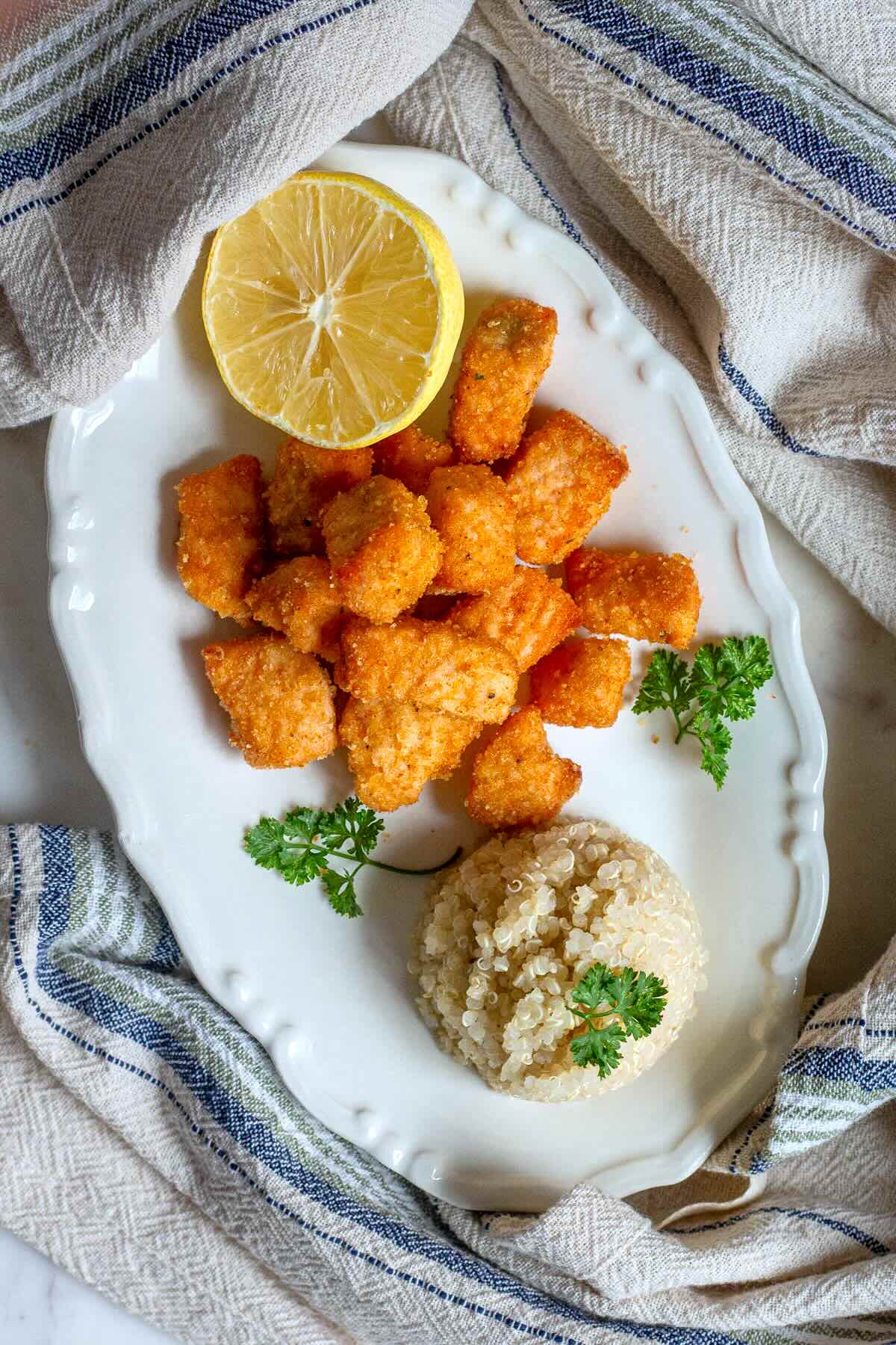 Air Fryer Salmon Bites with Garlic served on a plate with brown rice.