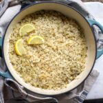 Mediterranean rice shown in a Dutch oven skillet and decorated with lemon
