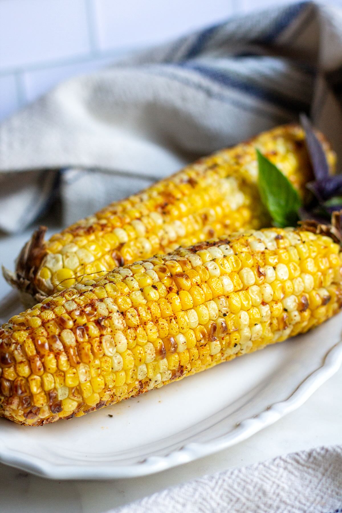 Crispy and juicy corn on the cob cooked in Ninja air fryer.