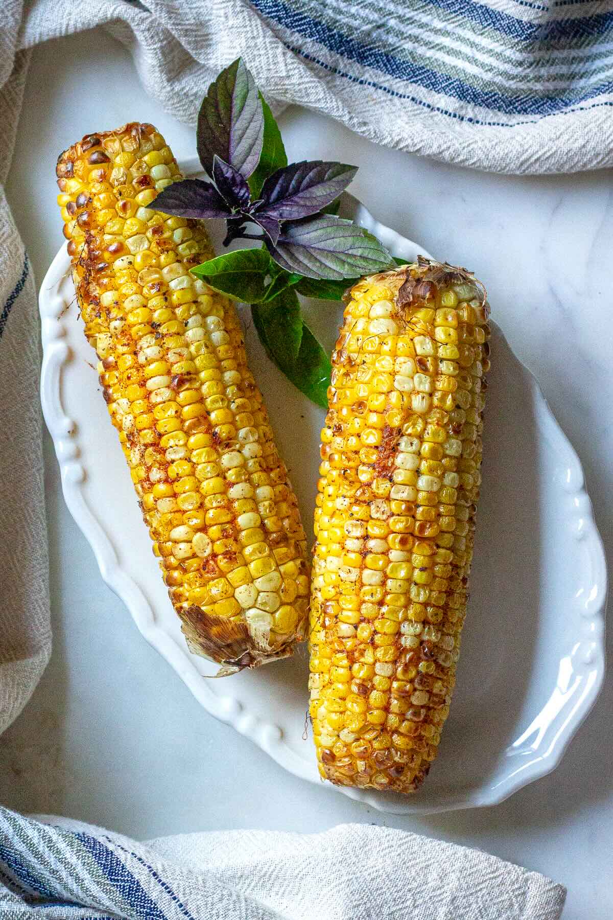 Crispy and juicy corn on the cob cooked in Ninja air fryer.