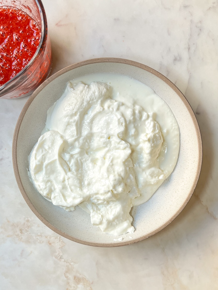 Strawberry Yogurt recipe, add strawberry yogurt to a bowl.