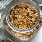 Homemade granola meal prepped and stored in a large glass jar
