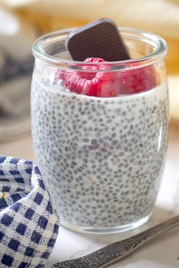 Overnight chia pudding with kefir topped with fresh berries and dark chocolate