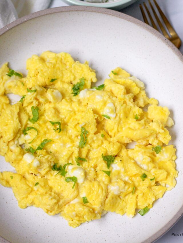 Cheesy Scrambled Eggs, sprinkled with greens.
