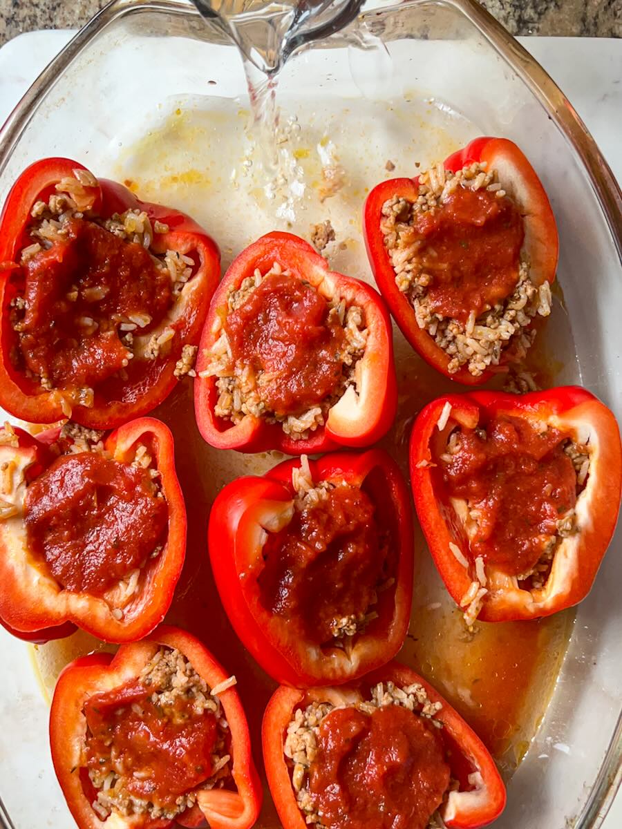 Gluten Free Meat and Rice Stuffed Peppers, add water to stuffed peppers.