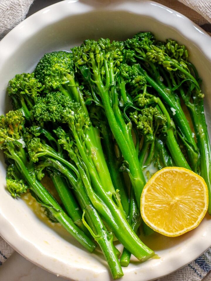 Steamed Broccolini with Garlic and Lemon Sauce served in a dish.