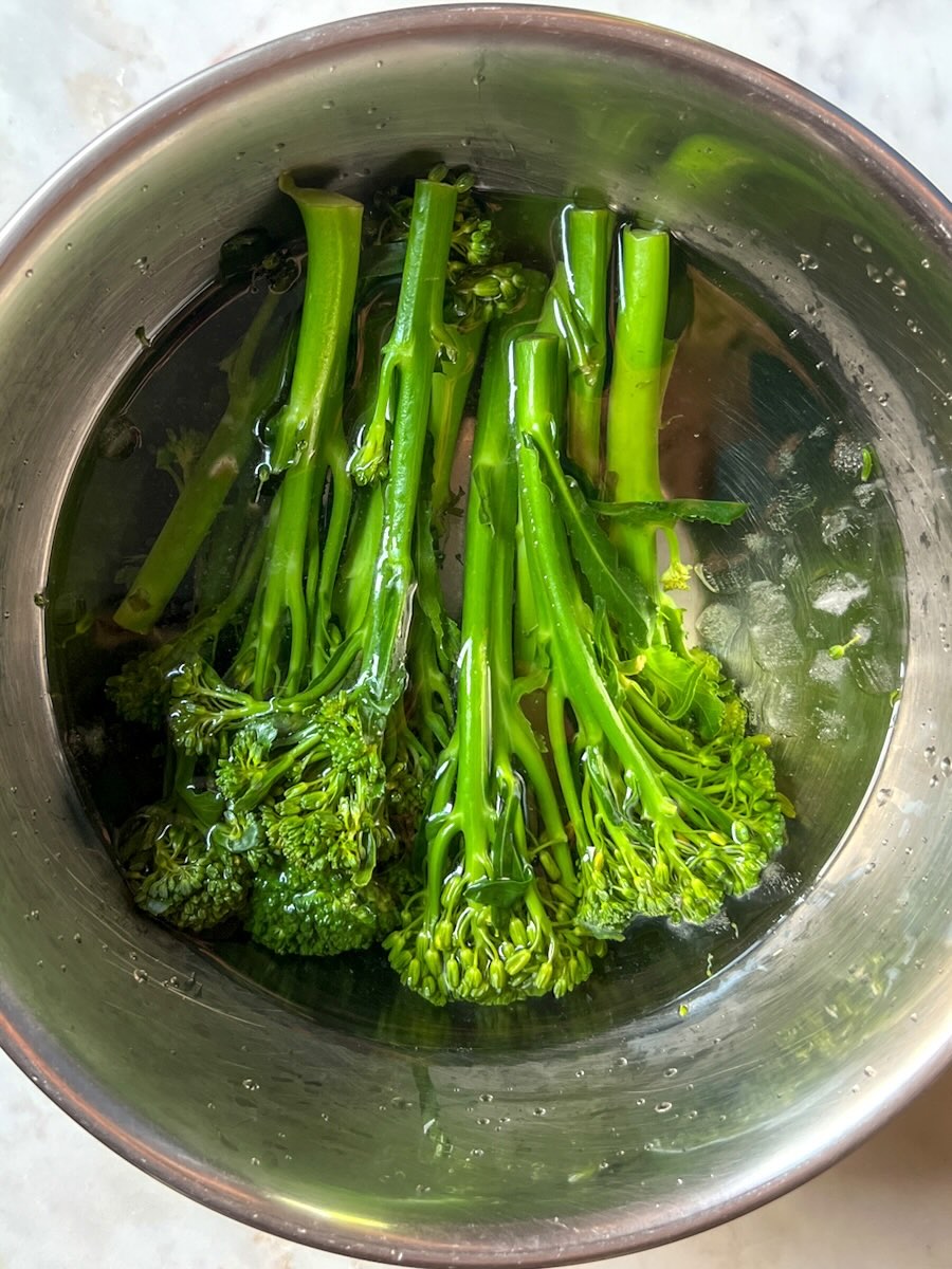 Steamed Broccolini with garlic and lemon, dip broccolini in cold water to stop cooking and to preserve color.