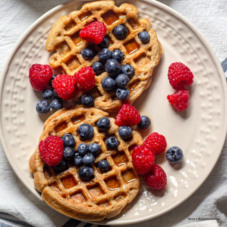 Apple Waffles Served on a Plate with Maple Syrup and Raspberries and Blueberries