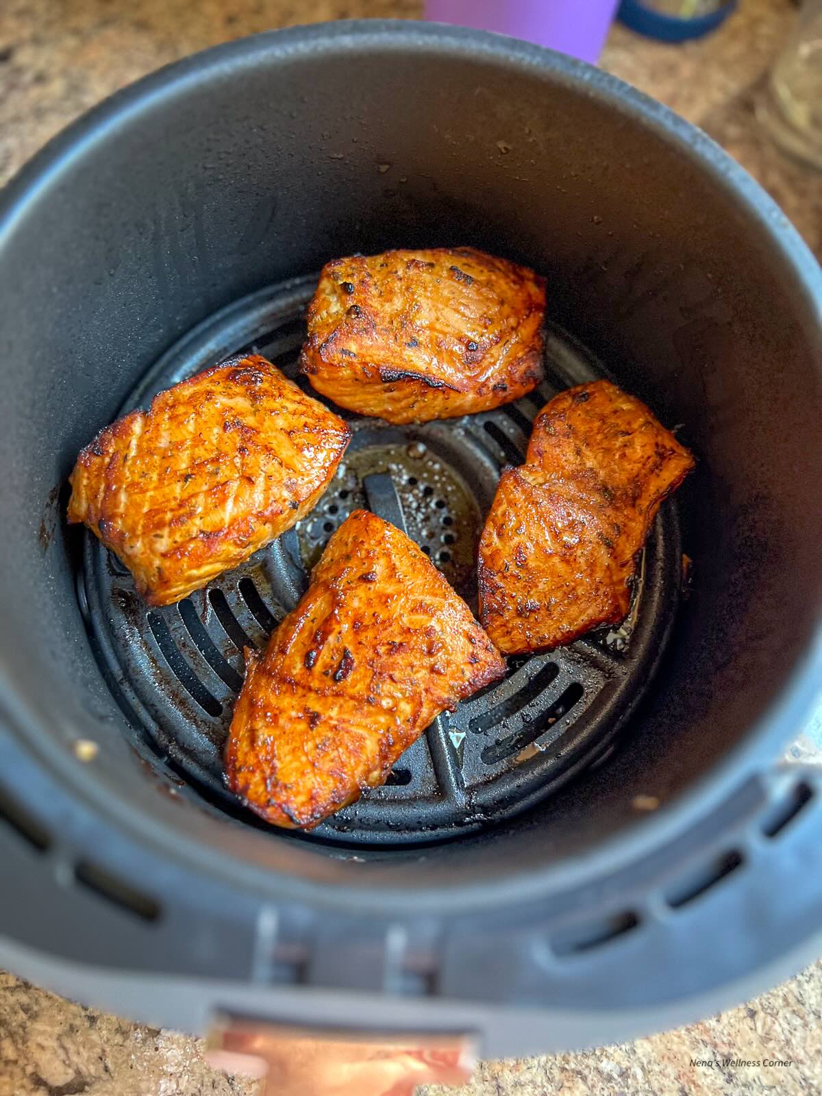 Air fryer maple salmon in an air fryer basket