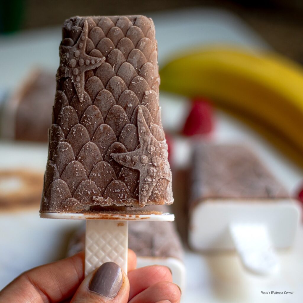 Chocolate and banana popsicles with raspberries