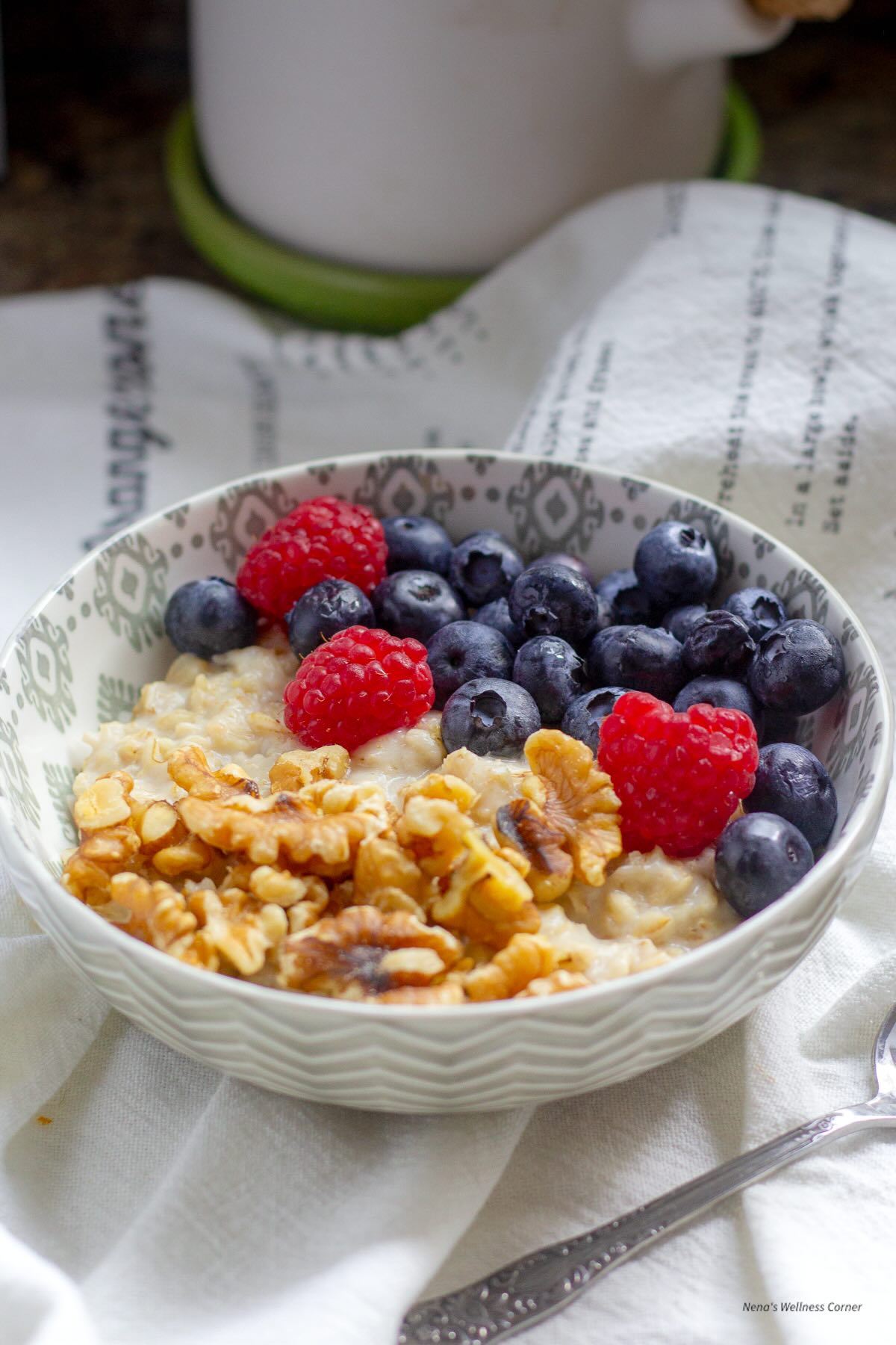 Oatmeal with berries and walnuts served in a breakfast bowl