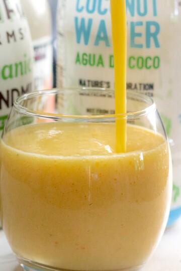 Vegan orange tropical smoothie served in a cup