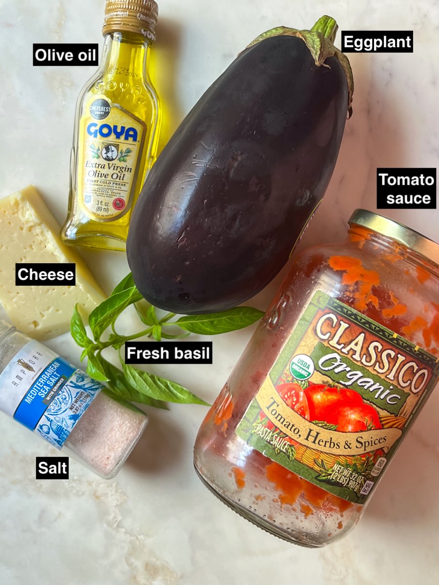 Ingredients for easy cheesy eggplant casserole: eggplant, salt, olive oil, tomato sauce, shredded mozzarella, and fresh basil.
