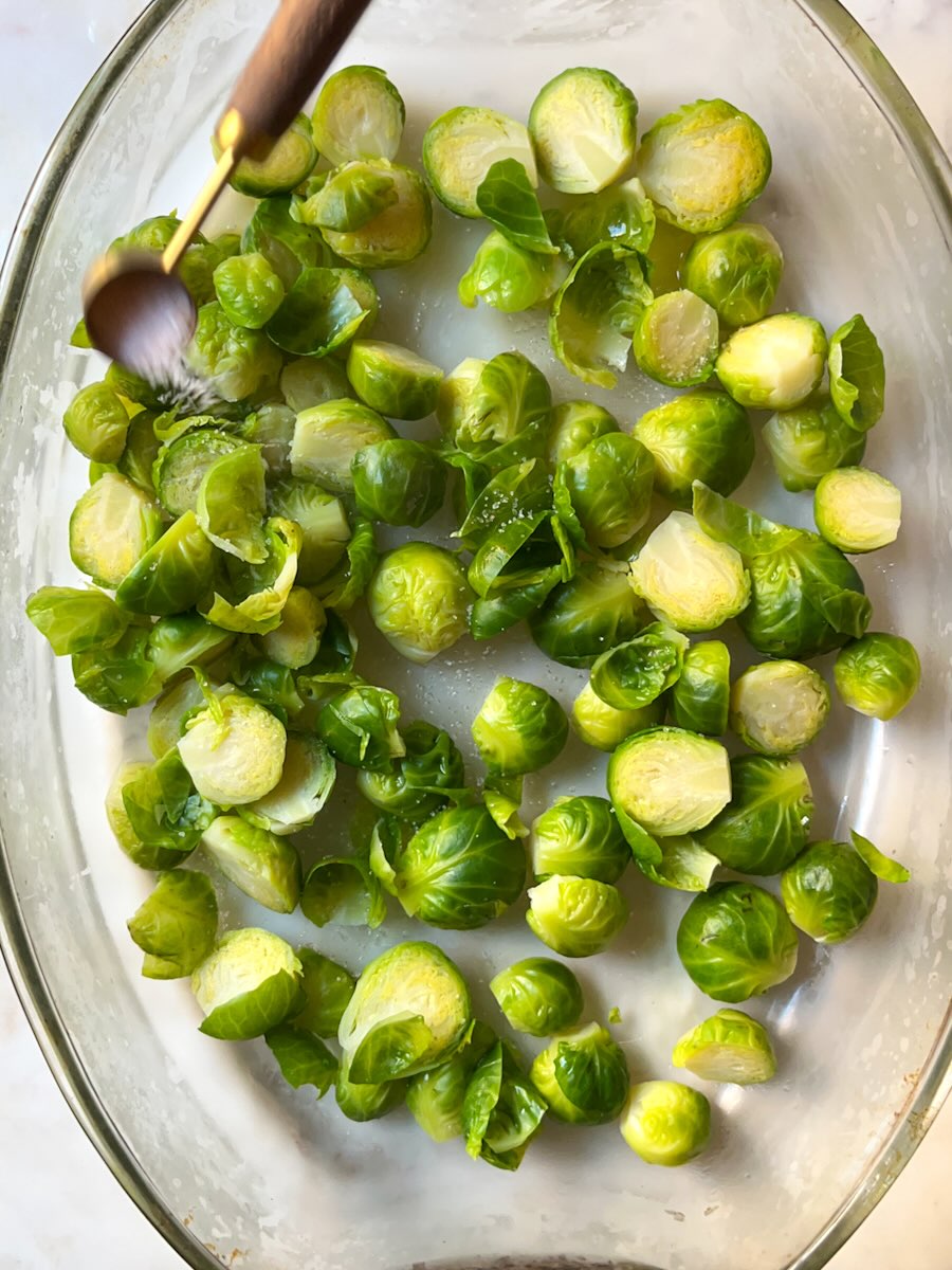 Oven Baked Brussels Sprout with Prosciutto, add olive oil and seasoning.