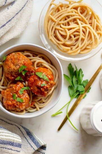 Mini Turkey Meatballs with Tomato Sauce served in a bowl over spaghetti