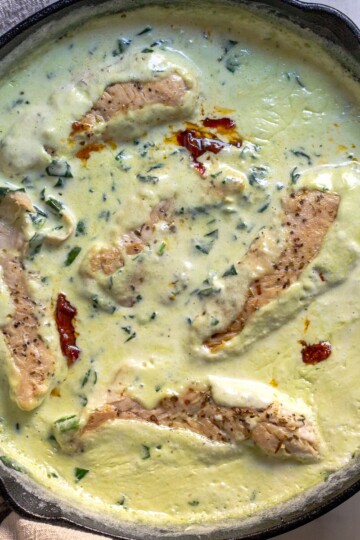Creamy chicken spinach with sundried tomatoes in a skillet