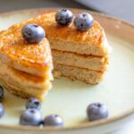 Banana pancakes with maple syrup and blueberries.