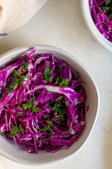 Freshly prepared red cabbage salad with olive oil, salt, and pepper.