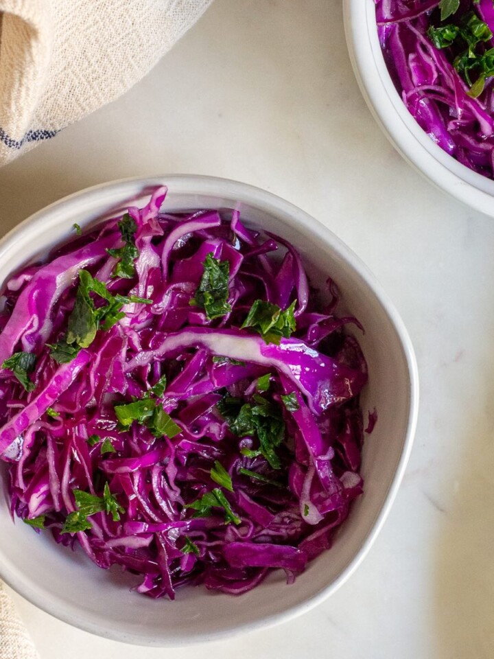 Freshly prepared red cabbage salad with olive oil, salt, and pepper.