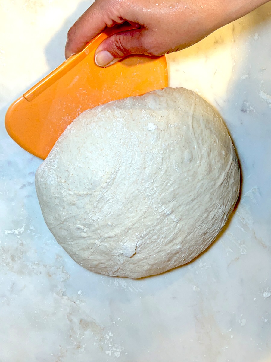 Sourdough bread recipe for beginners shaping the dough.