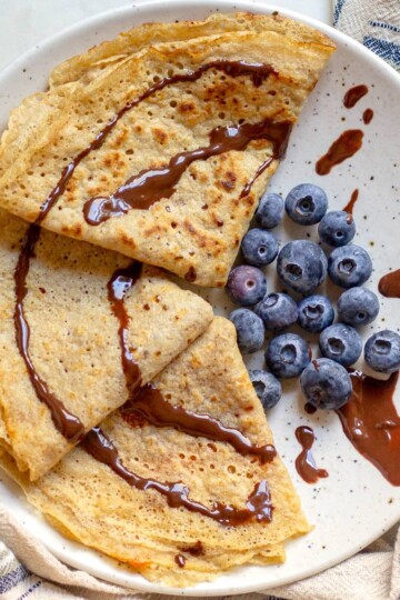 Whole-wheat crepes served on a plate with blueberries