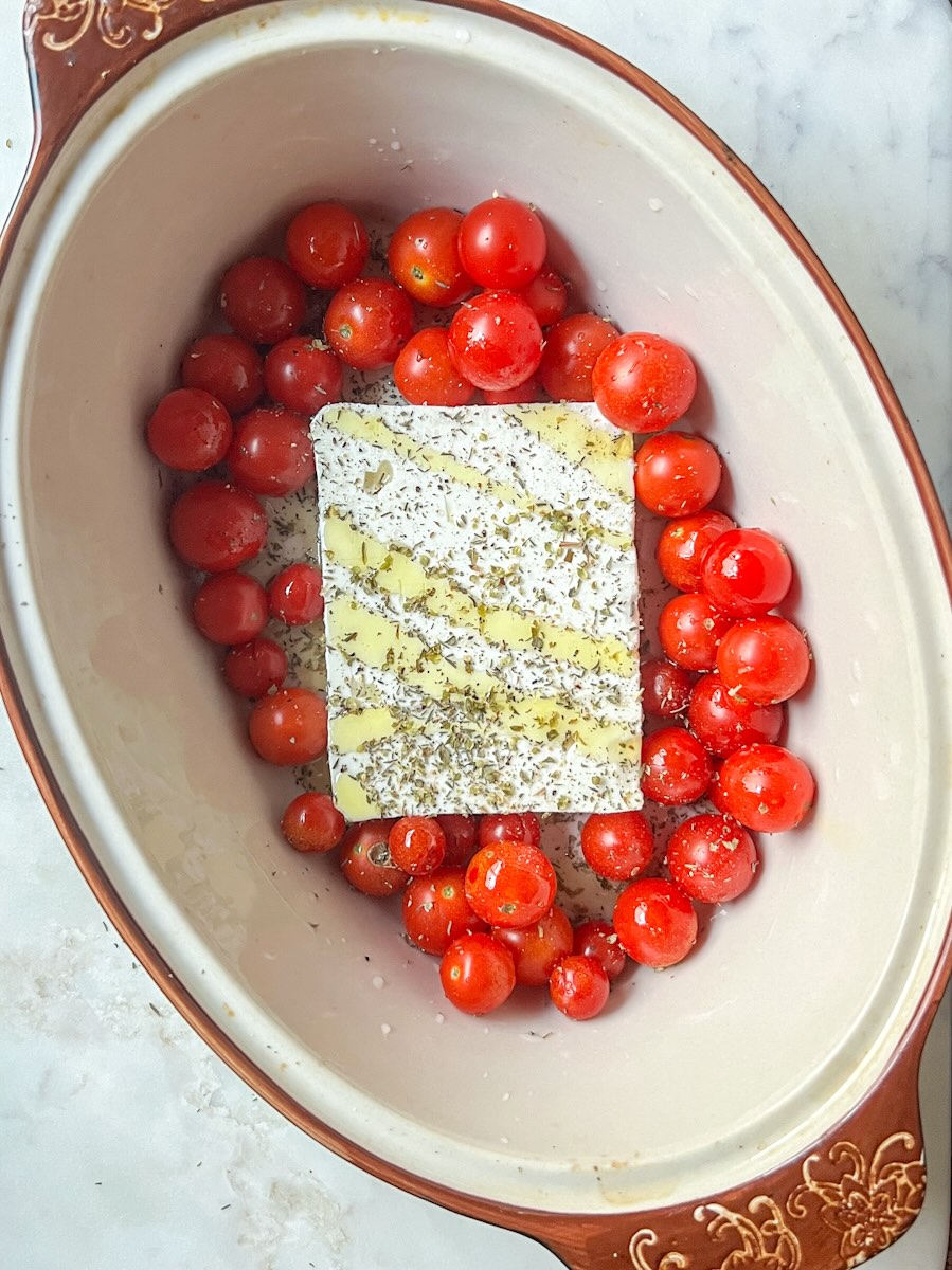 Baked feta pasta, add cherry tomatoes and spices to feta. 