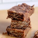 Homemade granola bars made without peanut butter, using almond butter, coconut oil, honey, and chocolate chips for a healthy, protein-packed snack.