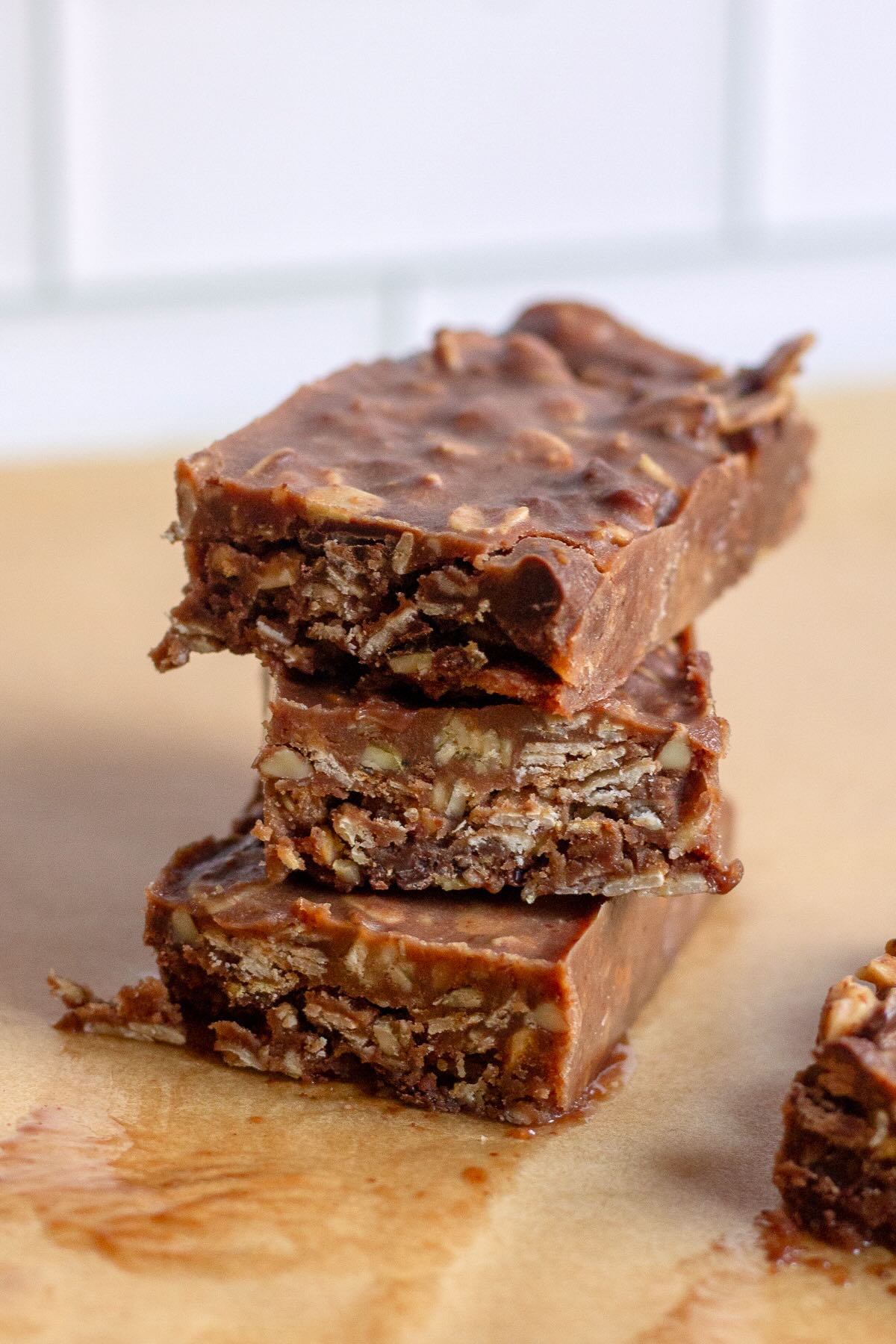 Homemade granola bars made without peanut butter, using almond butter, coconut oil, honey, and chocolate chips for a healthy, protein-packed snack.
