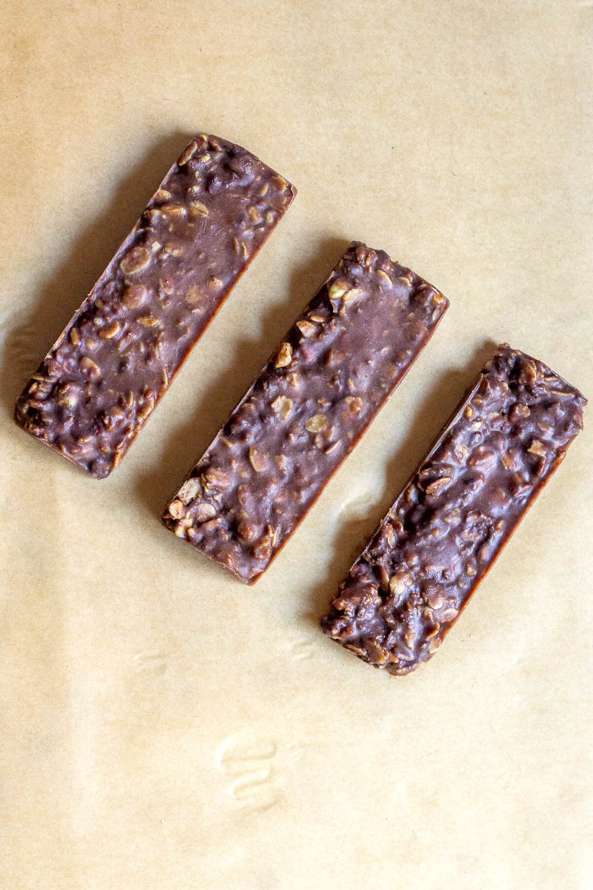 Homemade granola bars made without peanut butter, using almond butter, coconut oil, honey, and chocolate chips for a healthy, protein-packed snack.