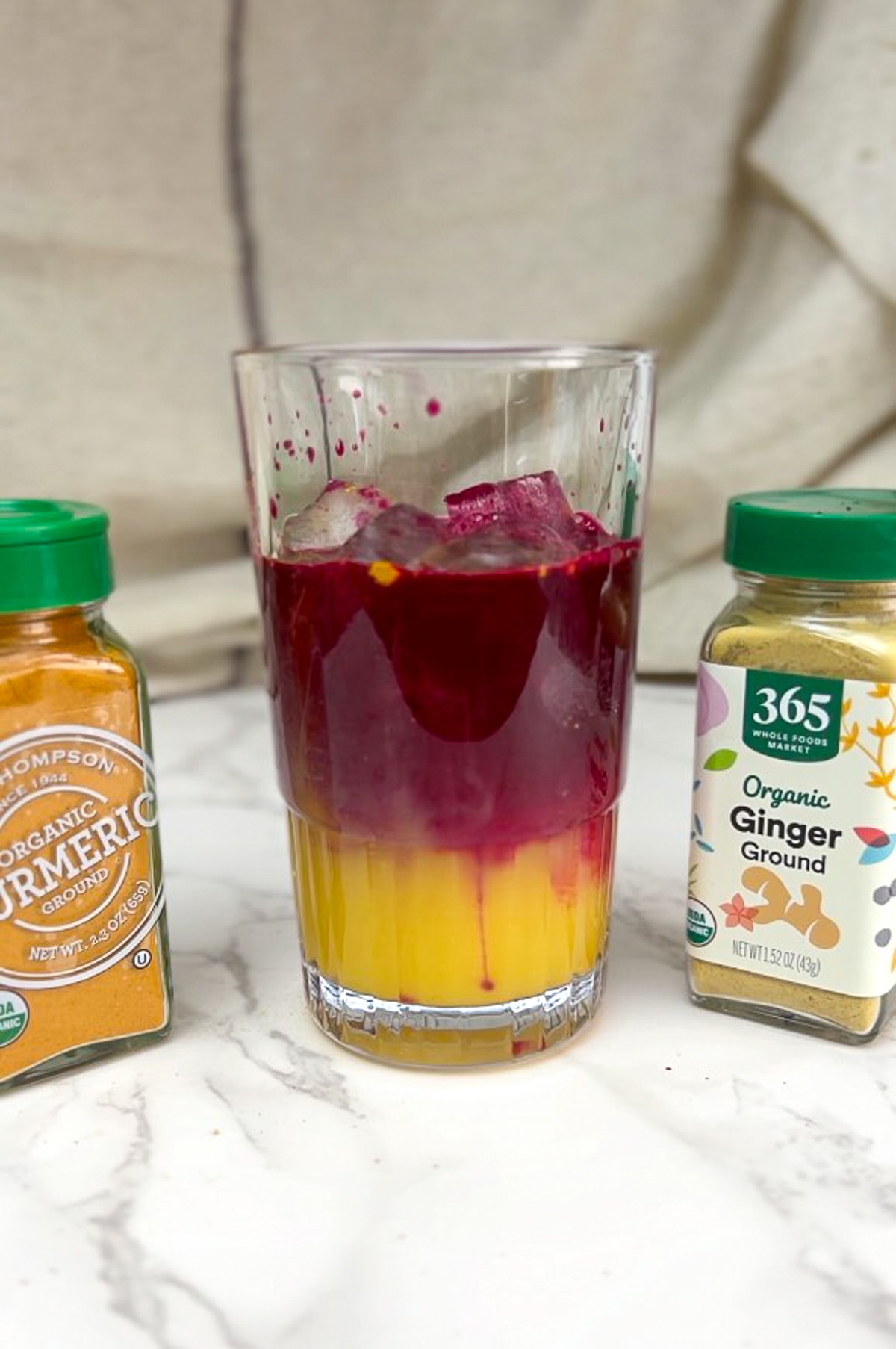 Morning meditation juice freshly prepared and served in a tall glass over ice cubes.