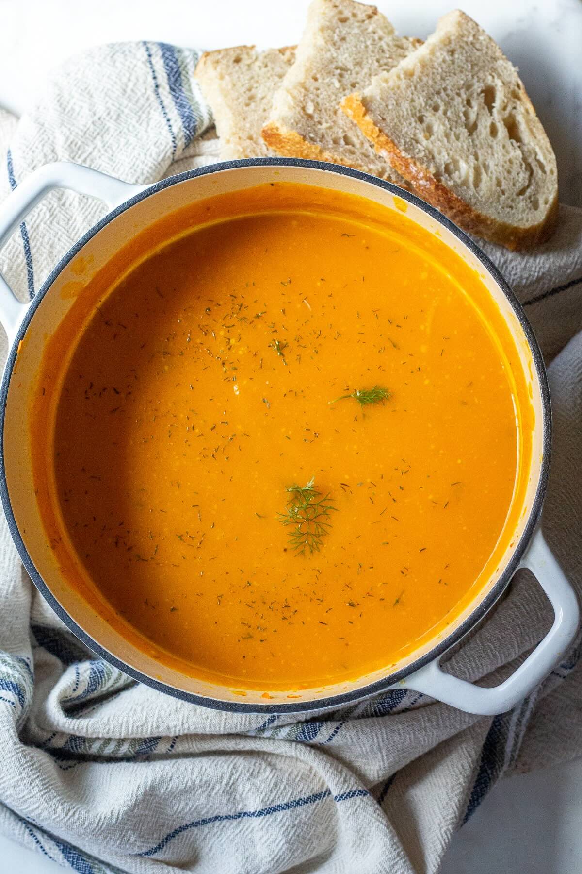 Sweet potato soup with zucchini and garlic in a pot.