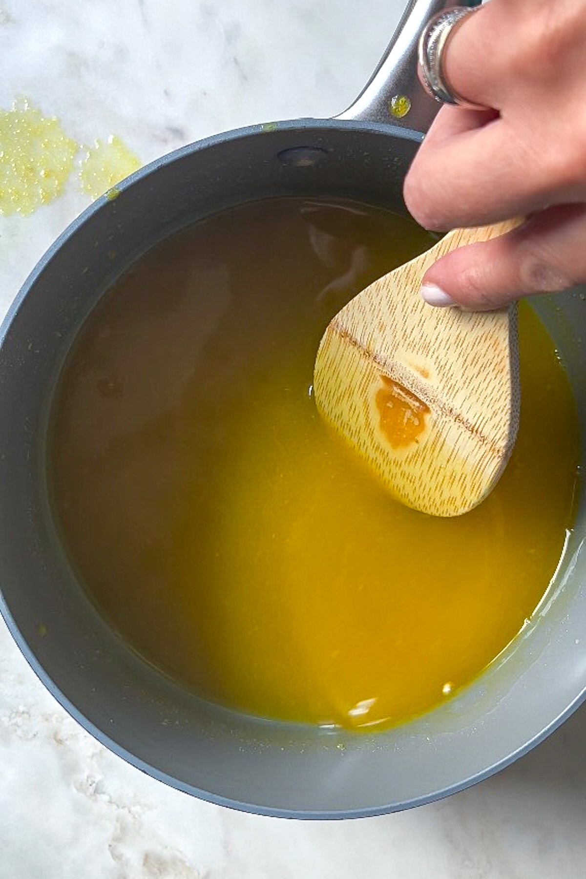 Turmeric ginger gummies, add the bloomed gelatine to the heated mixture. 