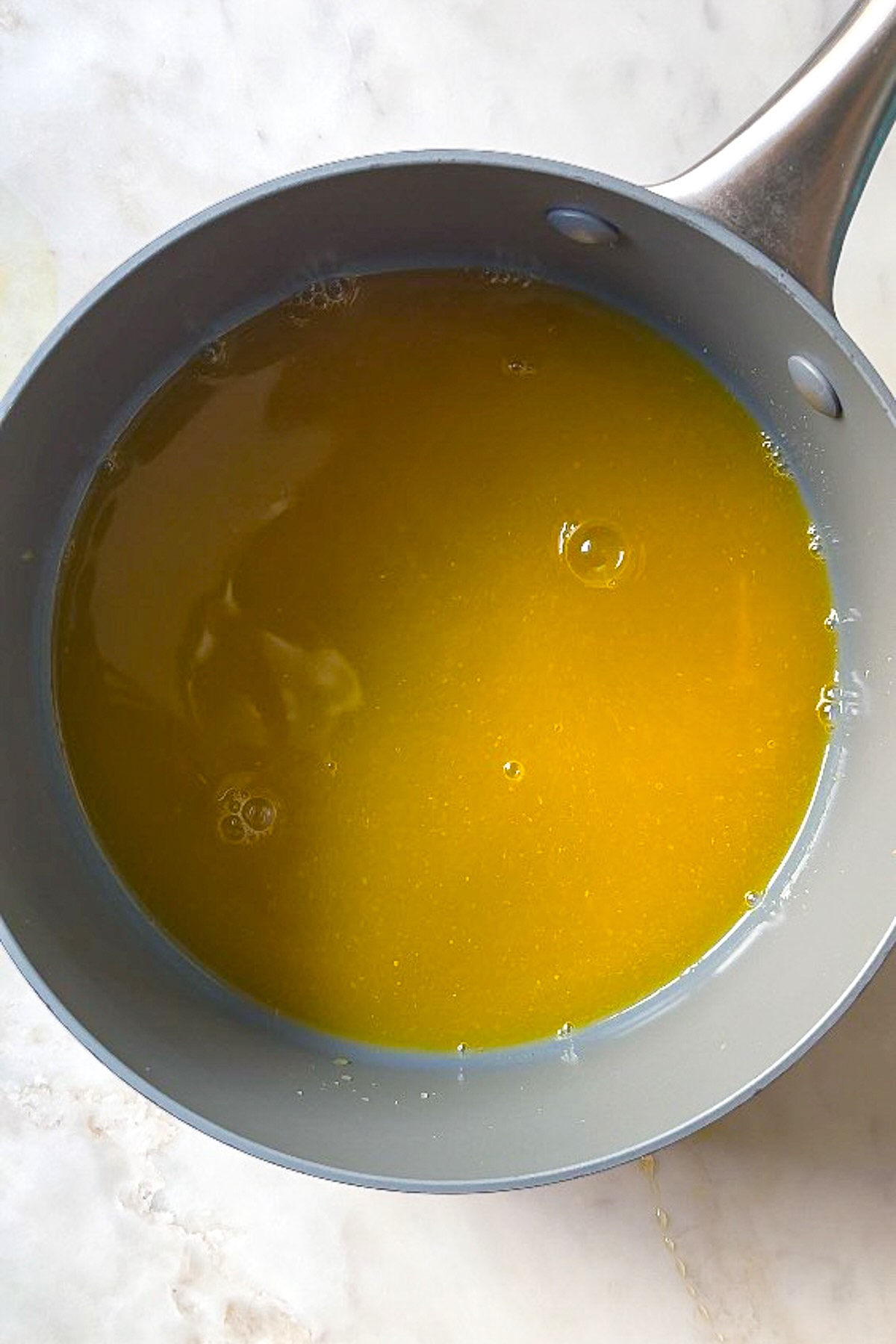 Turmeric ginger gummies, add honey and heat the mixture. 