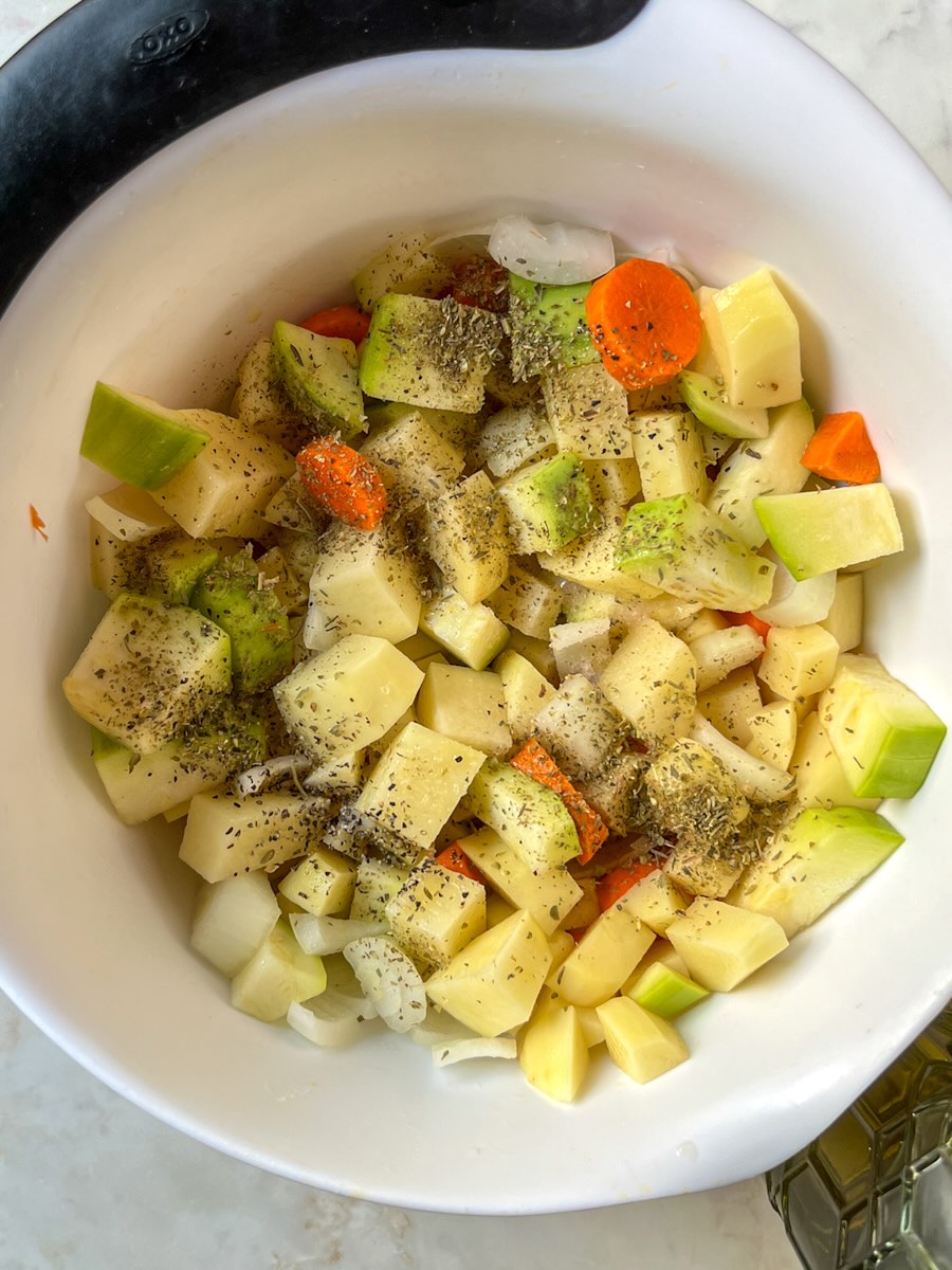 Oven roasted potatoes and carrots with onion and zucchini, add salt, pepper and Italian seasoning.