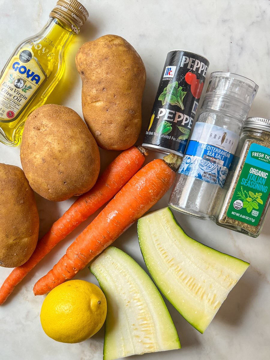 Oven roasted potatoes and carrots with onion and zucchini, ingredients.