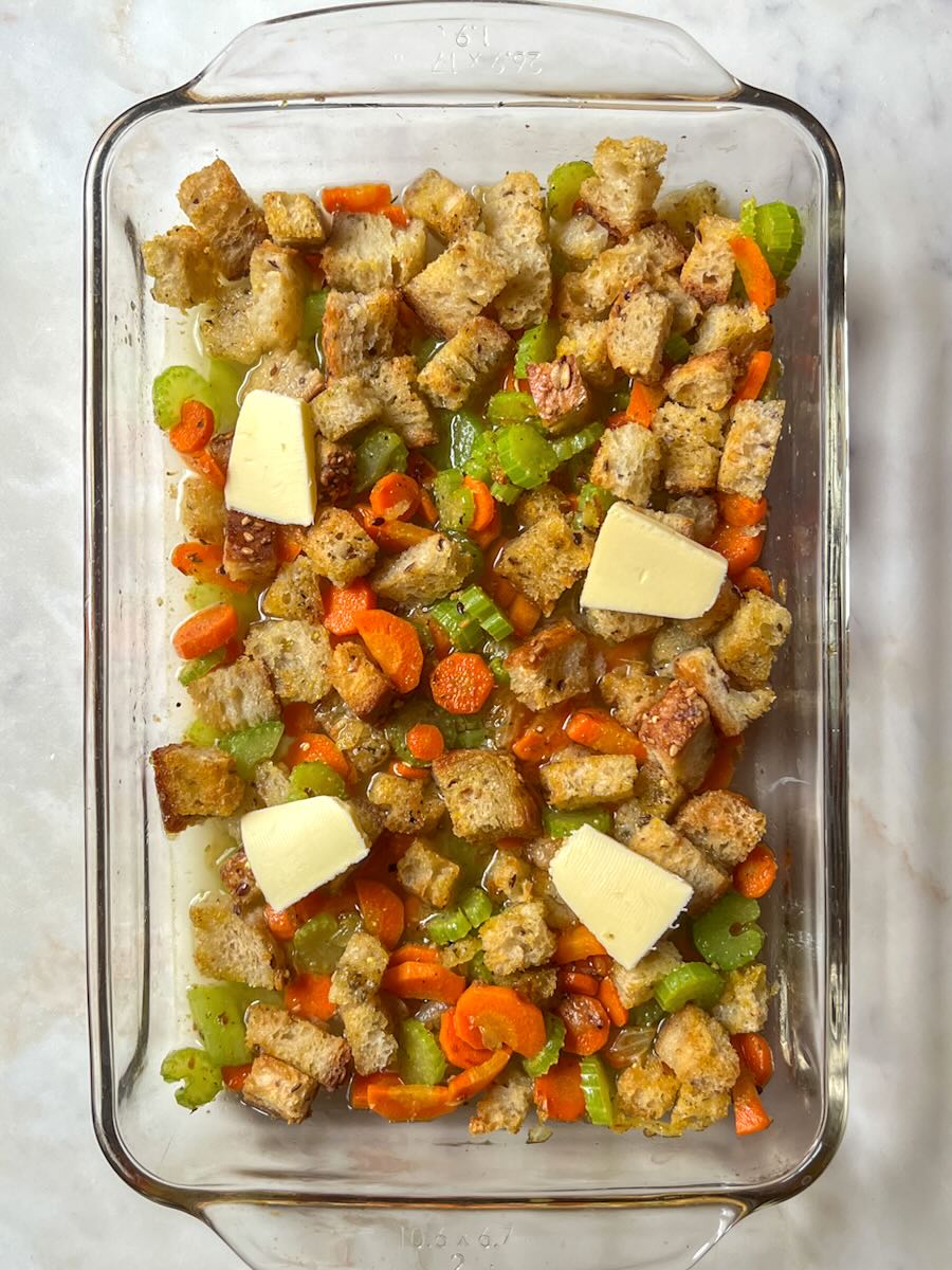 Vegetable stuffing casserole, add butter slices to the casserole.