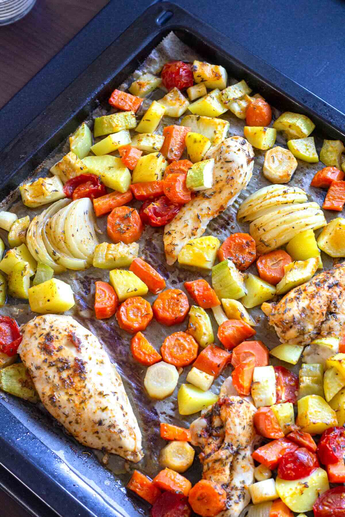 Mediterranean Sheet Pan Chciken and Veggies shown right after baking.