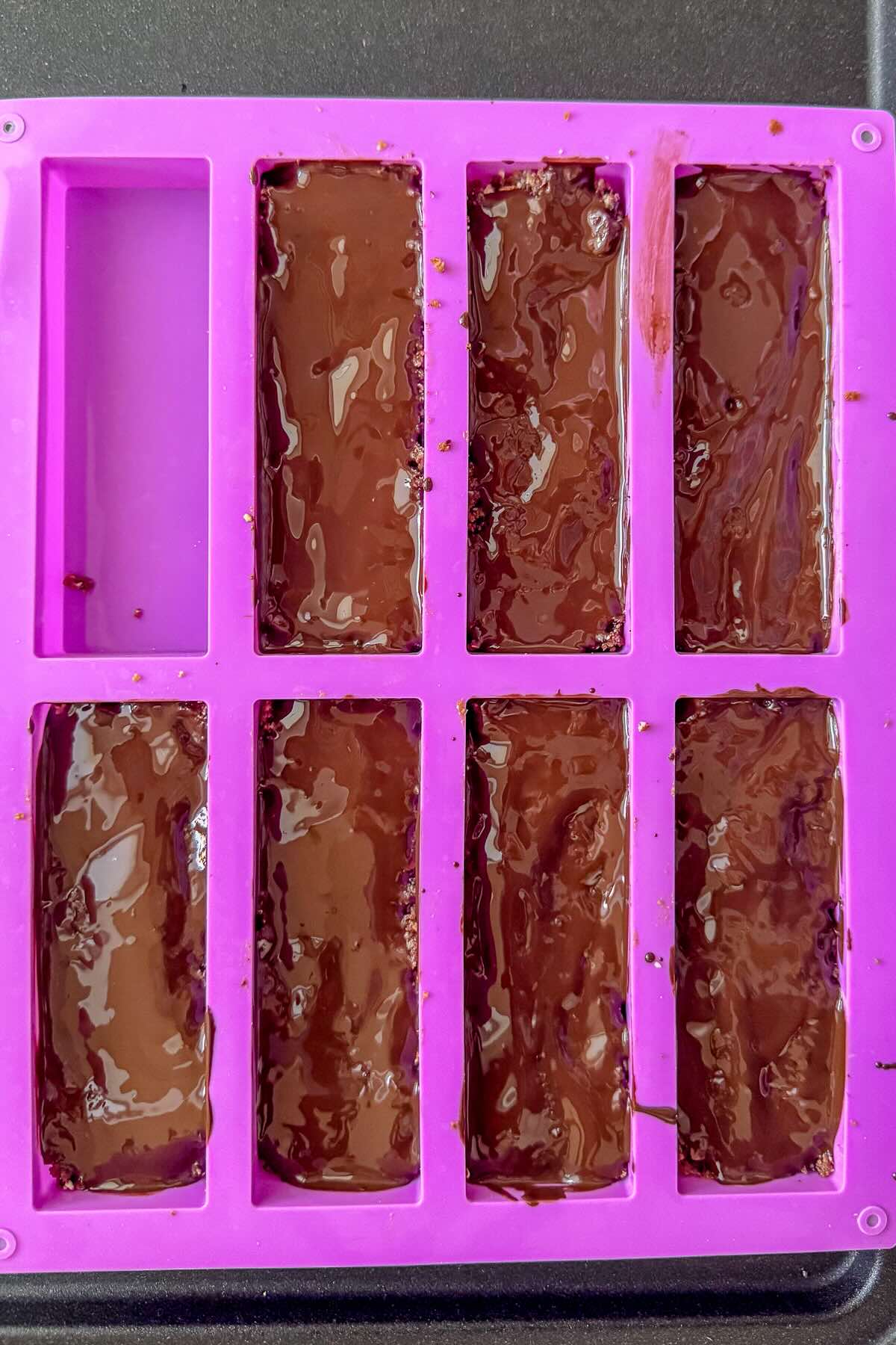 Date and nut bar, adding melted chocolate.