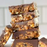 Date and nut bars stacked on a plate.