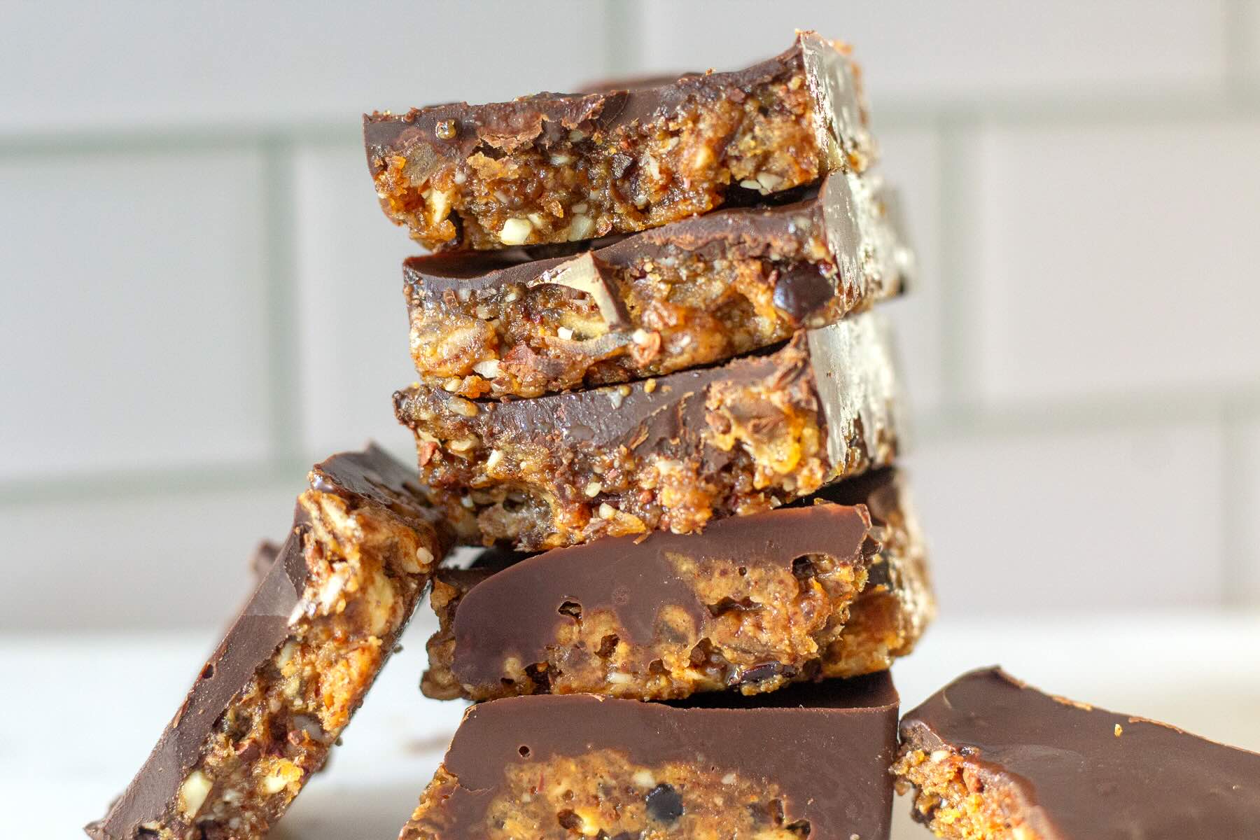 Date and nut bars stacked on a plate.