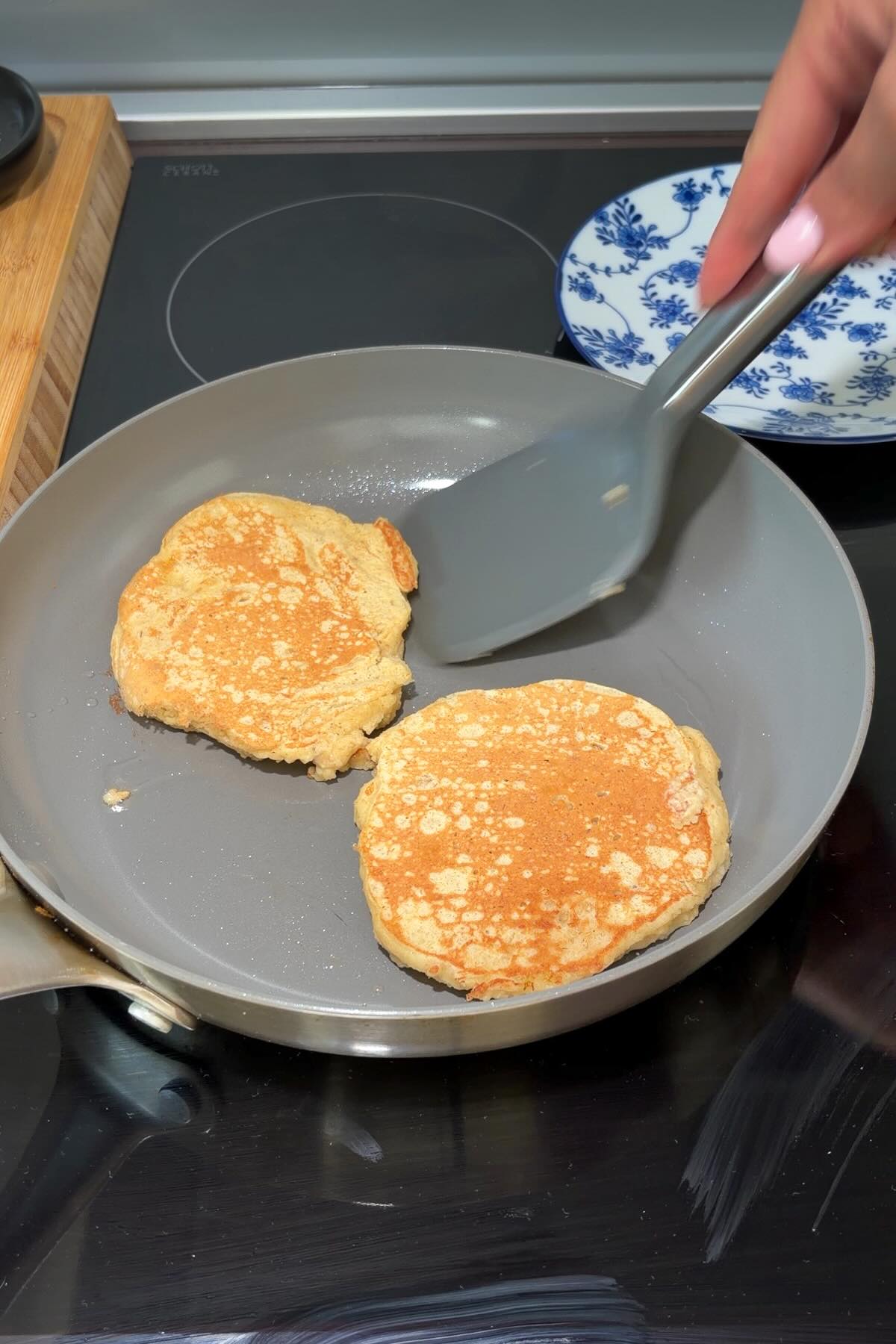 Gluten-free pancakes cooking on a griddle with bubbles forming on the surface