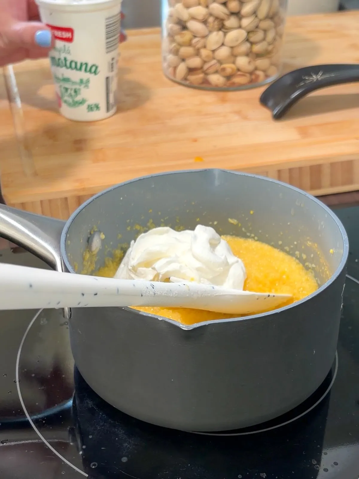 stirring-sour-cream-into-polenta